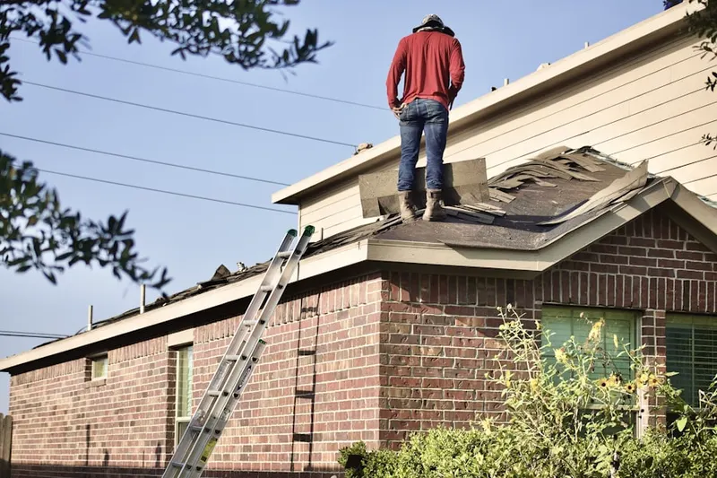 Professional roofer working on a residential roof in Geeseytown